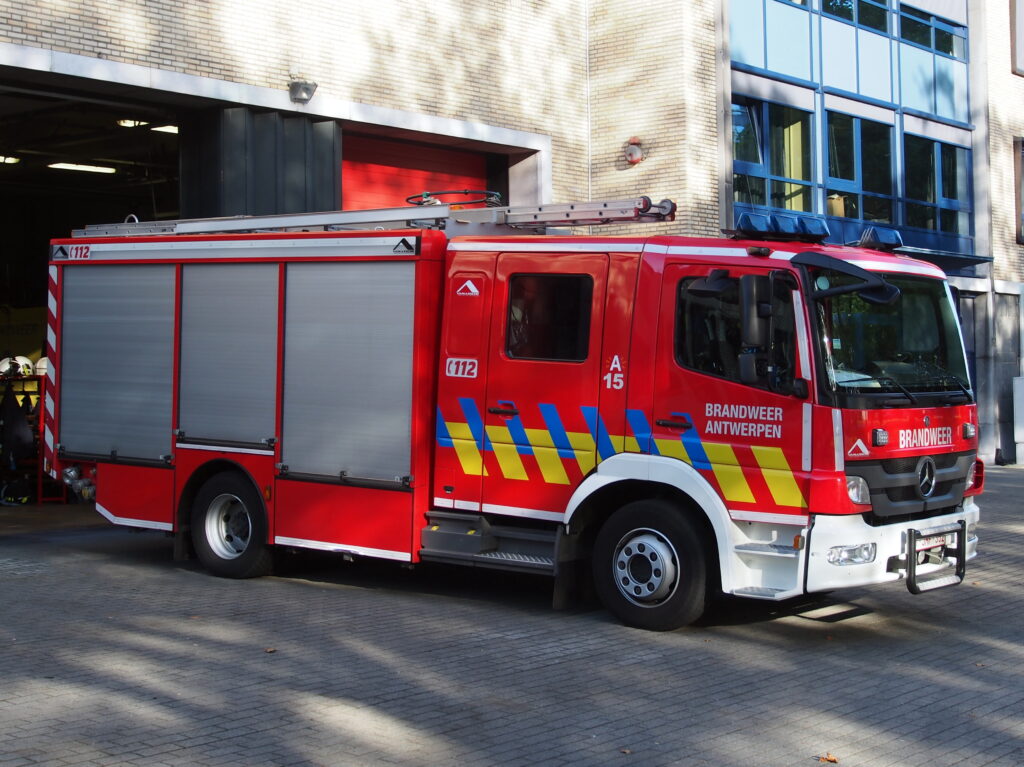 Red fire engine parked outside a fire station